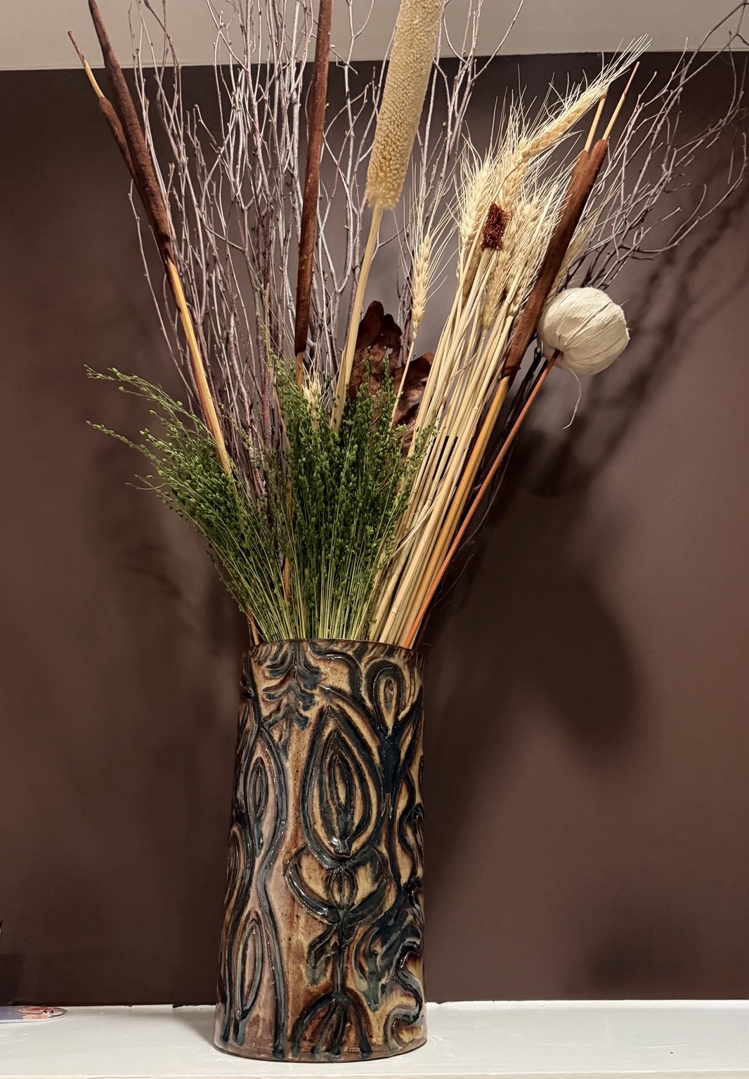 Earth-toned carved cylindrical vase